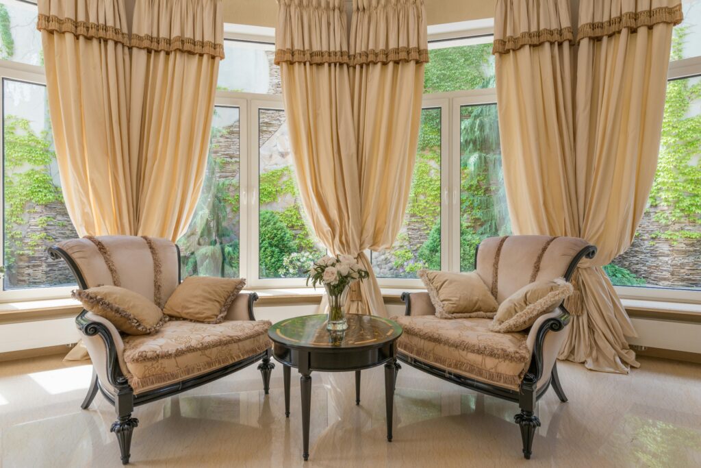 Luxurious living room with elegant armchairs, beige tones, and a peaceful ambiance.